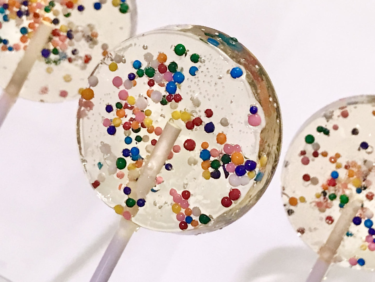 Set of 10 1.5" Lollipops filled with dye-free confetti sprinkles.