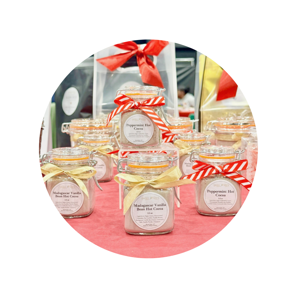 Mini glass jars filled with choice of hot cocoa flavor with decorative ribbon bow.