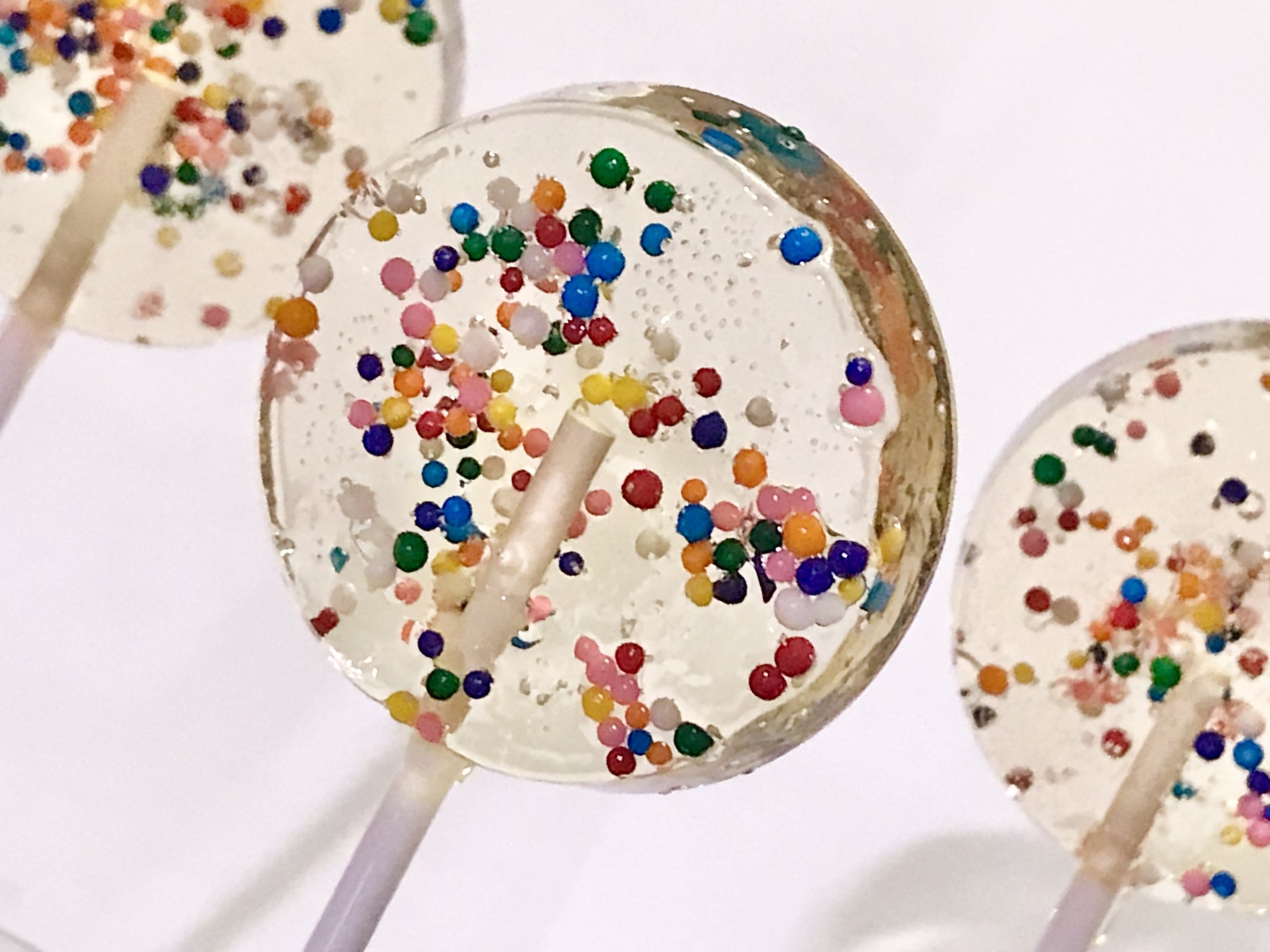 Set of 8 2" Lollipops filled with dye-free confetti sprinkles.